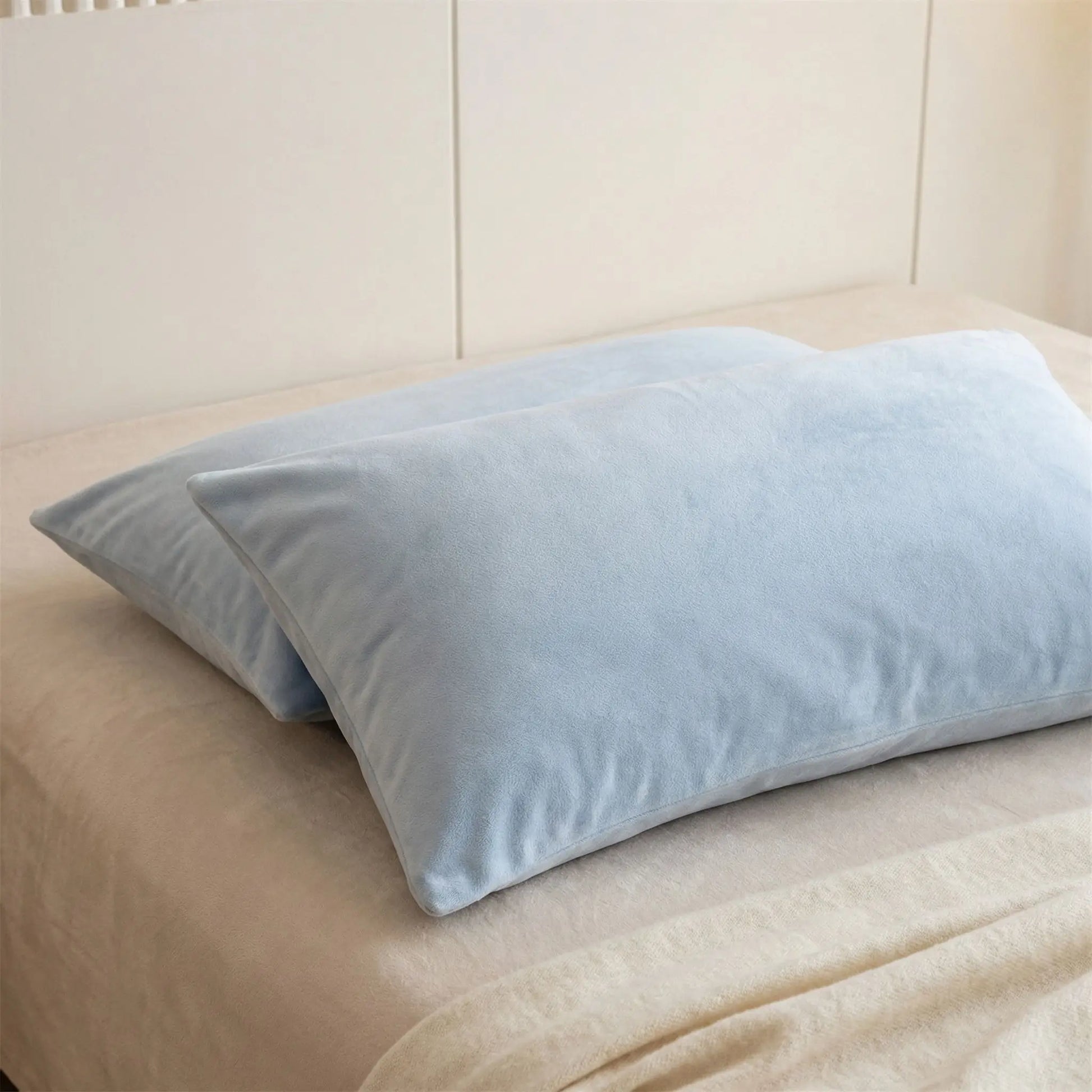 Détail de la texture d’une taie d’oreiller en velours bleu ciel, tissu doux, dense et légèrement lumineux