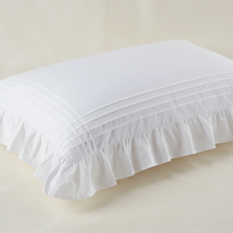 Taie d’oreiller en coton blanc à volants présentée seule sur fond clair