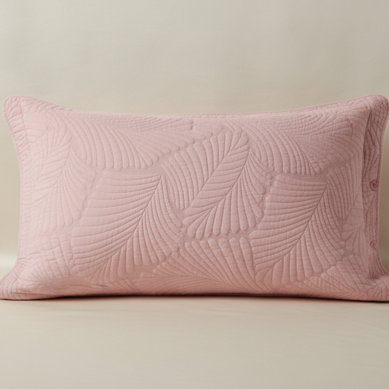 Taie d’oreiller en coton matelassé rose poudrée présentée seule sur fond clair